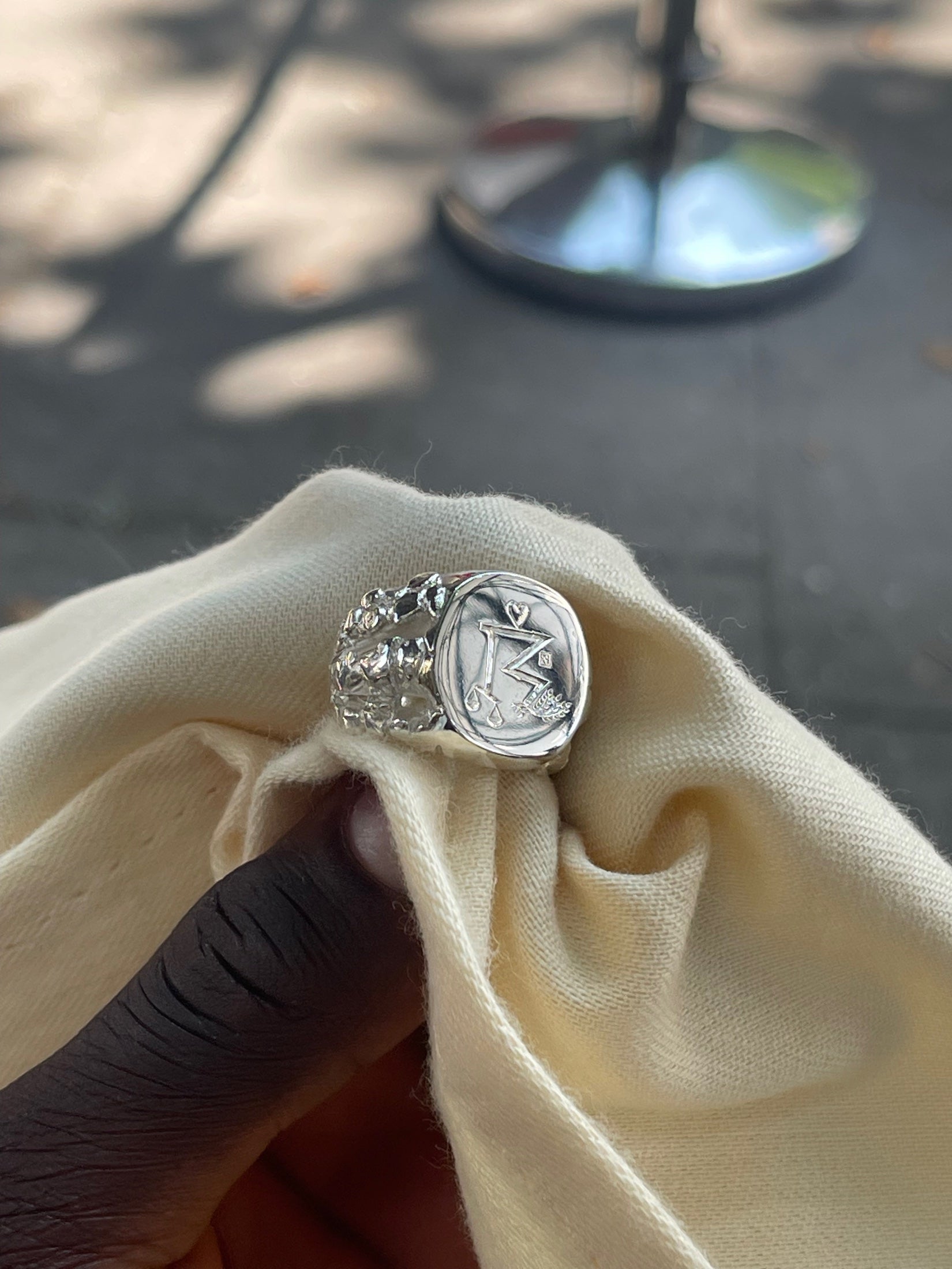 Kairo's finished bespoke wedding ring held in its original cloth at handover